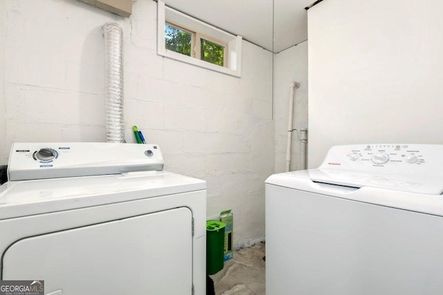 677 Holmes St NW, Atlanta, GA 30318 - laundry room with concrete block wall and separate washer and dryer