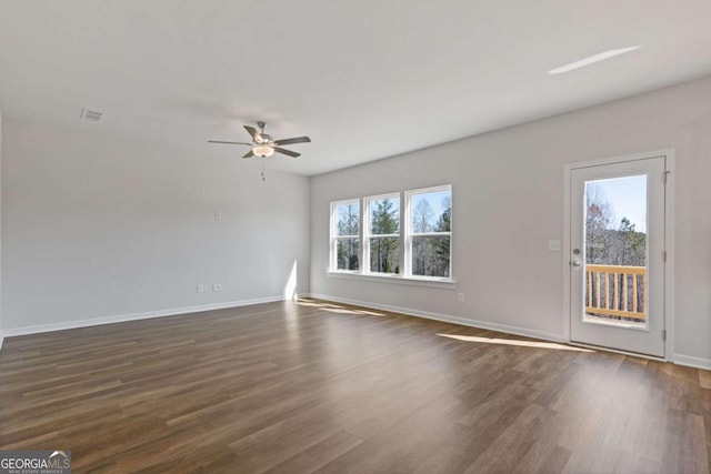 427 Buck Trl, Dallas, GA 30132 - unfurnished living room featuring dark wood-type flooring, ceiling fan, and baseboards