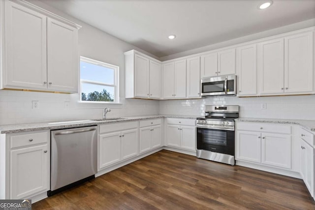 427 Buck Trl, Dallas, GA 30132 - kitchen with stainless steel appliances, a sink, white cabinets, backsplash, and recessed lighting