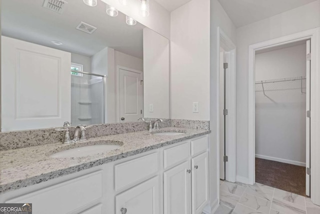 427 Buck Trl, Dallas, GA 30132 - full bath with a shower stall, double vanity, marble finish flooring, a spacious closet, and baseboards