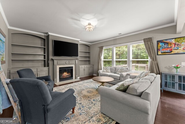 6160 Overleaf Ter, Cumming, GA 30040 - living room featuring crown molding, wood finished floors, a fireplace with flush hearth, and built in shelves