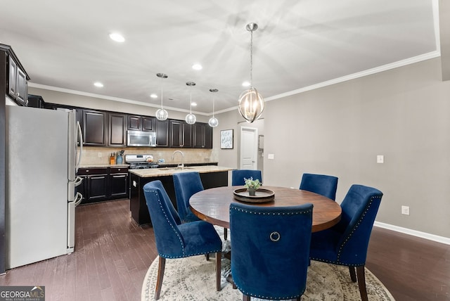 6160 Overleaf Ter, Cumming, GA 30040 - dining space featuring dark wood-style floors, crown molding, recessed lighting, and baseboards