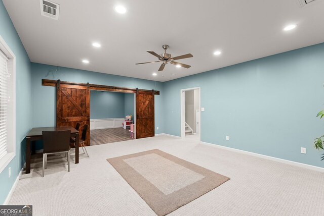 6160 Overleaf Ter, Cumming, GA 30040 - home office with a barn door, recessed lighting, ceiling fan, carpet floors, and baseboards