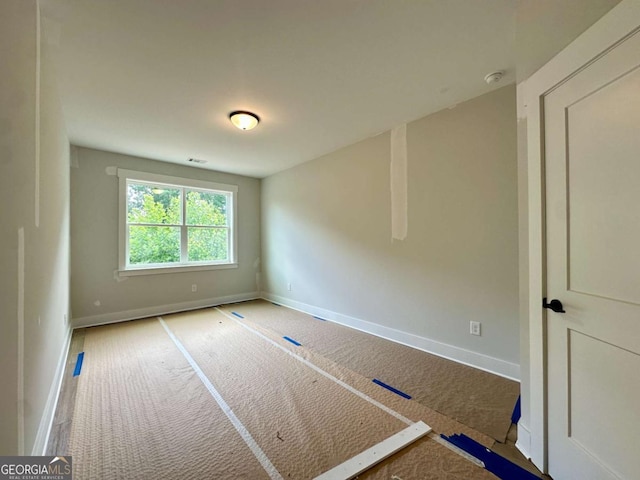 6819 Cambridge Dr, Flowery Branch, GA 30542 - carpeted empty room featuring baseboards and a smoke detector