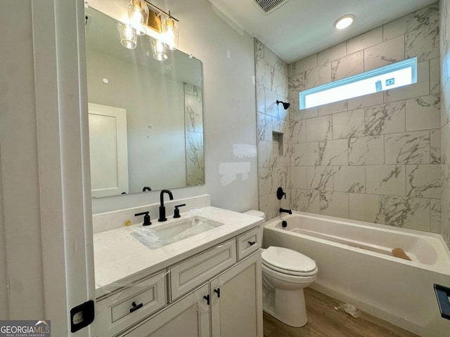 6819 Cambridge Dr, Flowery Branch, GA 30542 - bathroom featuring toilet, vanity, shower / tub combination, and wood finished floors