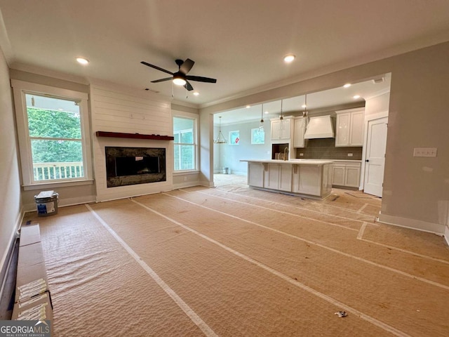 6819 Cambridge Dr, Flowery Branch, GA 30542 - unfurnished living room featuring ceiling fan, baseboards, healthy amount of natural light, recessed lighting, and ornamental molding