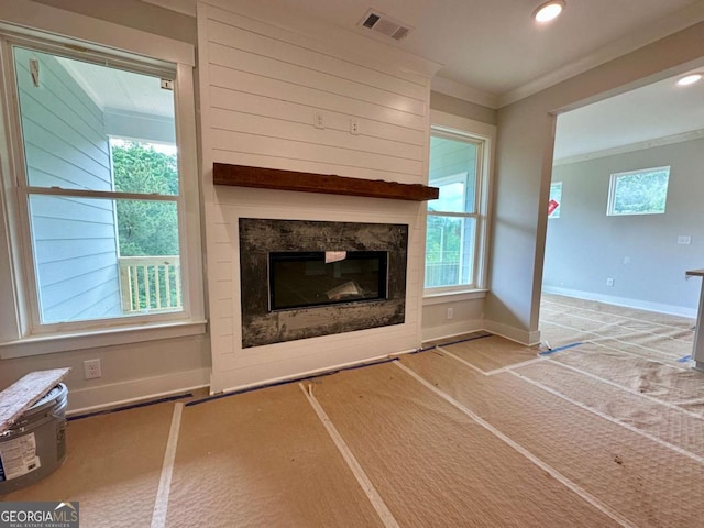 6819 Cambridge Dr, Flowery Branch, GA 30542 - unfurnished living room with a glass covered fireplace, ornamental molding, baseboards, recessed lighting, and carpet floors
