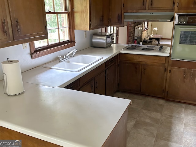 5125 Flakes Mill Rd, Ellenwood, GA 30294 - kitchen with oven, stainless steel electric cooktop, under cabinet range hood, light countertops, and a peninsula