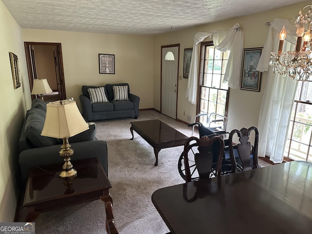 5125 Flakes Mill Rd, Ellenwood, GA 30294 - carpeted living room featuring a chandelier, a textured ceiling, and healthy amount of natural light