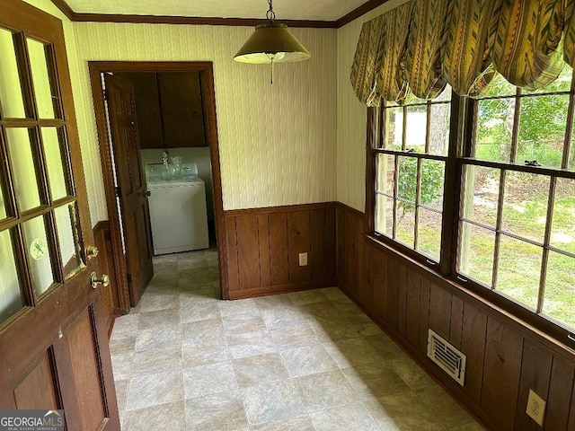 5125 Flakes Mill Rd, Ellenwood, GA 30294 - unfurnished dining area featuring plenty of natural light, ornamental molding, a wainscoted wall, wood walls, and light stone finish flooring