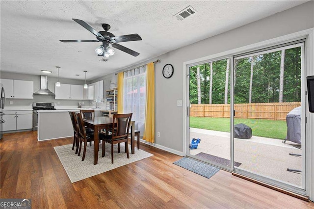 1047 Woodsong Pass Ct, Lawrenceville, GA 30043 - dining space featuring wood finished floors, ceiling fan, a textured ceiling, and baseboards