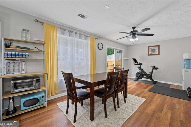 1047 Woodsong Pass Ct, Lawrenceville, GA 30043 - dining space featuring ceiling fan, wood finished floors, a textured ceiling, and baseboards