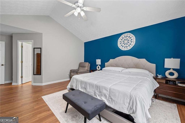 1047 Woodsong Pass Ct, Lawrenceville, GA 30043 - bedroom featuring wood finished floors, lofted ceiling, baseboards, and ceiling fan