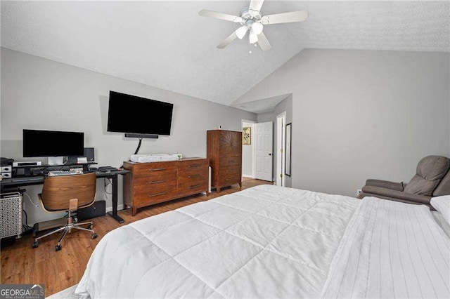 1047 Woodsong Pass Ct, Lawrenceville, GA 30043 - bedroom featuring wood finished floors, vaulted ceiling, a ceiling fan, and a desk