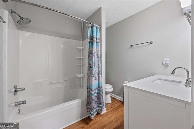 1047 Woodsong Pass Ct, Lawrenceville, GA 30043 - full bathroom with toilet, shower / bath combination with curtain, wood finished floors, vanity, and a textured ceiling