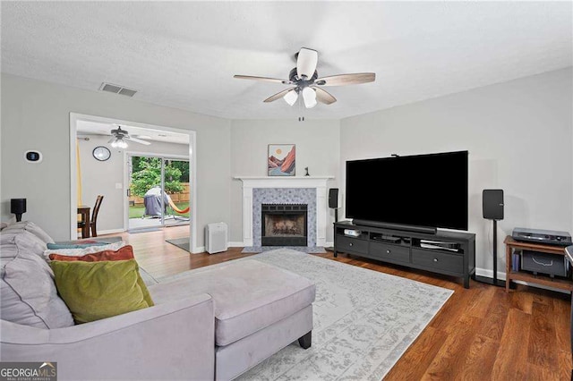 1047 Woodsong Pass Ct, Lawrenceville, GA 30043 - living area featuring a ceiling fan, wood finished floors, a fireplace, and baseboards