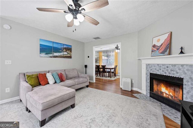 1047 Woodsong Pass Ct, Lawrenceville, GA 30043 - living area with ceiling fan, baseboards, wood finished floors, and a tile fireplace