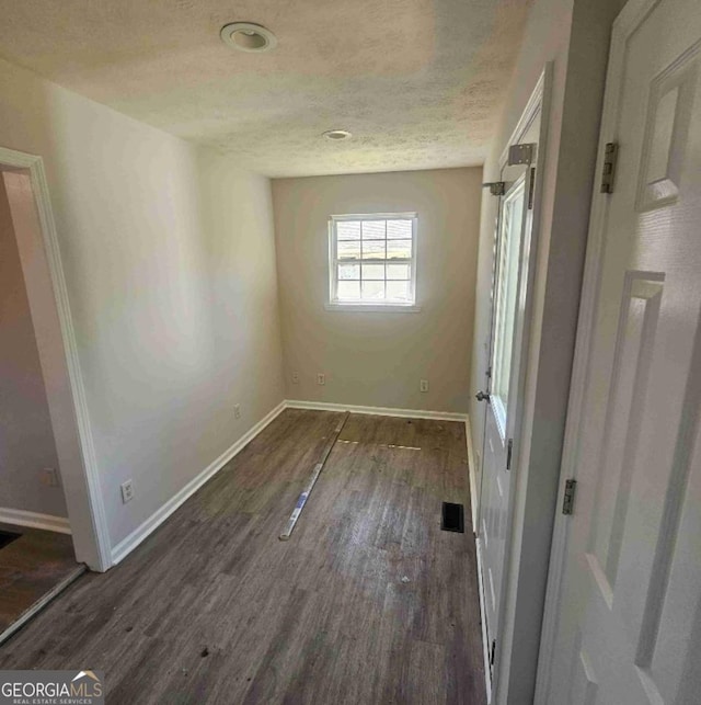 359 Hoyt St, Cornelia, GA 30531 - unfurnished bedroom with wood finished floors, baseboards, and a textured ceiling