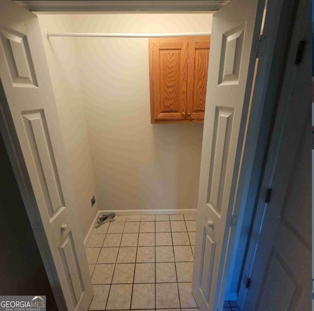 359 Hoyt St, Cornelia, GA 30531 - laundry area with cabinet space, baseboards, and light tile patterned floors
