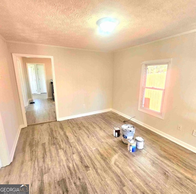 359 Hoyt St, Cornelia, GA 30531 - empty room with a textured ceiling, wood finished floors, ornamental molding, and baseboards
