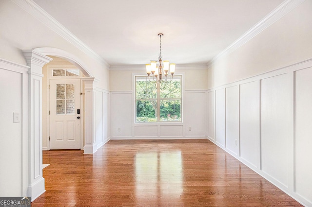 14 Mcgregor Ln, Dawsonville, GA 30534 - unfurnished dining area featuring a decorative wall, a chandelier, wood finished floors, ornamental molding, and a wainscoted wall