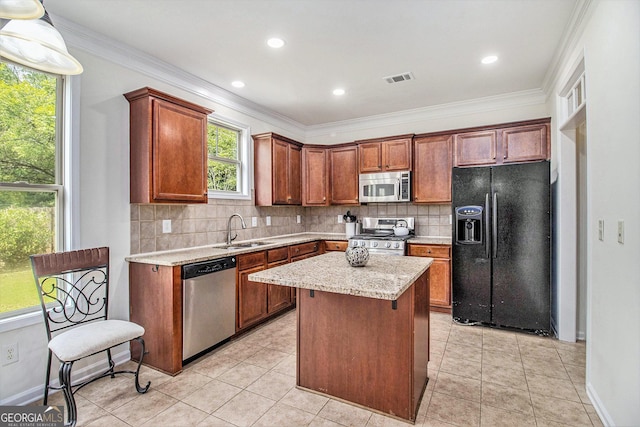 14 Mcgregor Ln, Dawsonville, GA 30534 - kitchen with appliances with stainless steel finishes, a sink, backsplash, a kitchen island, and ornamental molding