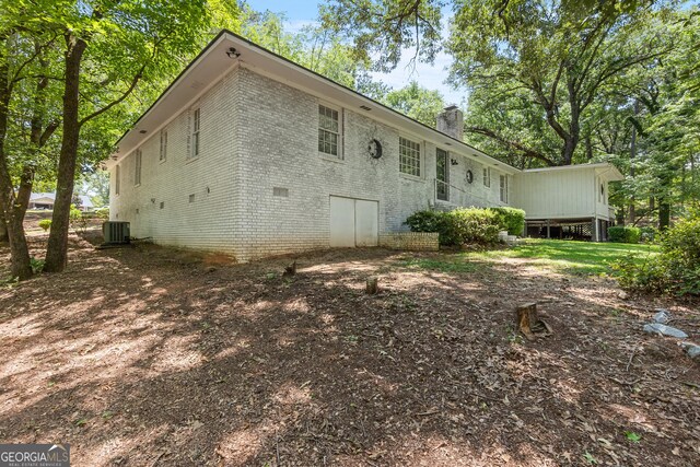 467 Kirkland Dr, Byron, GA 31008 - back of property featuring brick siding, cooling unit, and a chimney