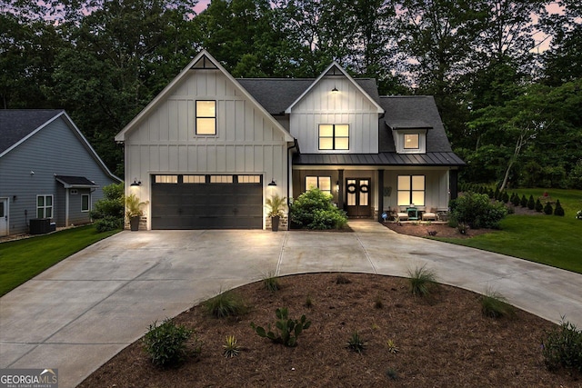 2490 S Carroll St, Villa Rica, GA 30180 - modern farmhouse with board and batten siding, covered porch, driveway, and an attached garage