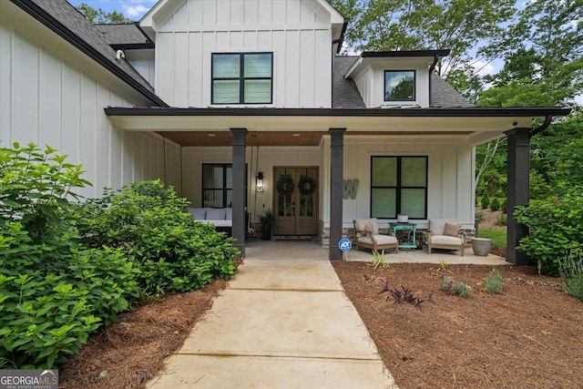 2490 S Carroll St, Villa Rica, GA 30180 - property entrance with french doors, board and batten siding, covered porch, and a shingled roof