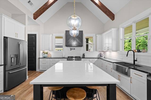 2490 S Carroll St, Villa Rica, GA 30180 - kitchen featuring stainless steel fridge with ice dispenser, a kitchen breakfast bar, high vaulted ceiling, custom range hood, and beamed ceiling