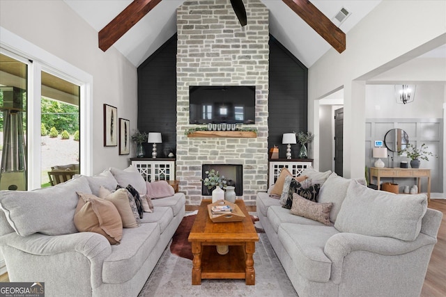 2490 S Carroll St, Villa Rica, GA 30180 - living room with wood finished floors, beamed ceiling, high vaulted ceiling, and a large fireplace