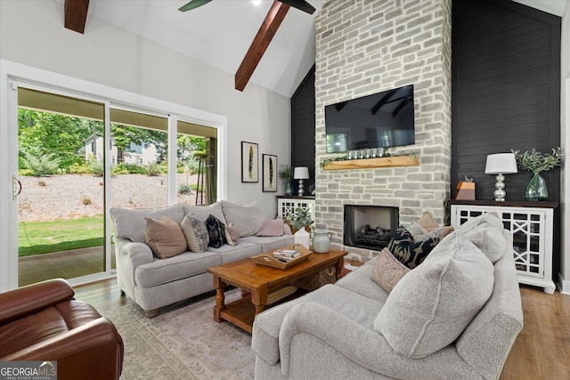 2490 S Carroll St, Villa Rica, GA 30180 - living room featuring high vaulted ceiling, wood finished floors, beam ceiling, ceiling fan, and a fireplace