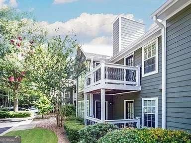 510 Berkeley Woods Dr, Duluth, GA 30096 - rear view of property with a balcony and a chimney
