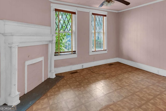 507 W 35th St, Savannah, GA 31415 - unfurnished living room with crown molding, ceiling fan, wooden walls, and baseboards