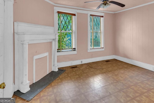507 W 35th St, Savannah, GA 31415 - unfurnished living room with tile patterned floors, crown molding, ceiling fan, wood walls, and baseboards