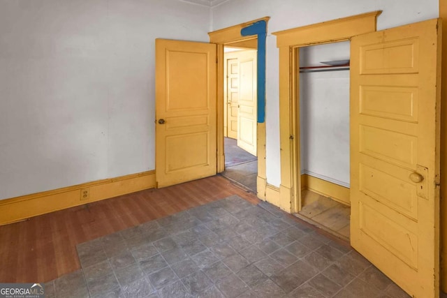 507 W 35th St, Savannah, GA 31415 - unfurnished bedroom with dark wood-style floors, baseboards, and a closet