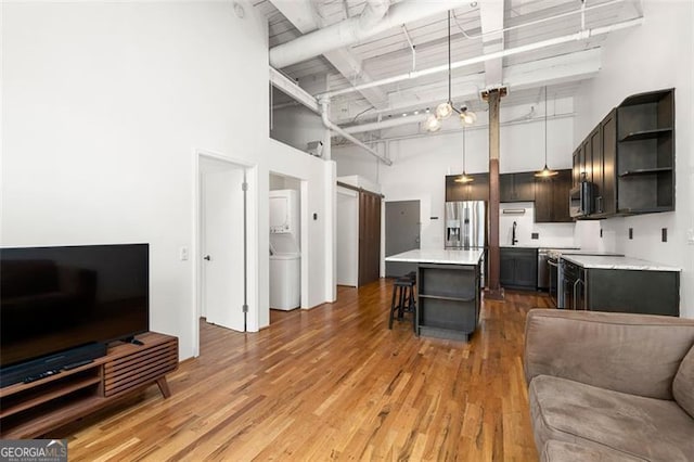 210 Walker St Unit 3, Atlanta, GA 30313 - kitchen with a high ceiling, open shelves, open floor plan, a kitchen breakfast bar, and light countertops