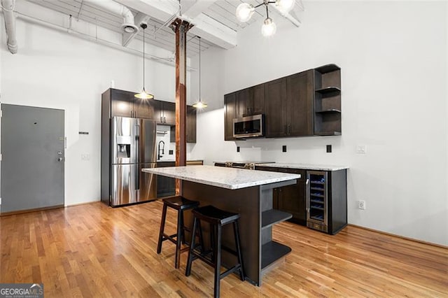 210 Walker St Unit 3, Atlanta, GA 30313 - kitchen with appliances with stainless steel finishes, a high ceiling, open shelves, dark brown cabinetry, and beverage cooler