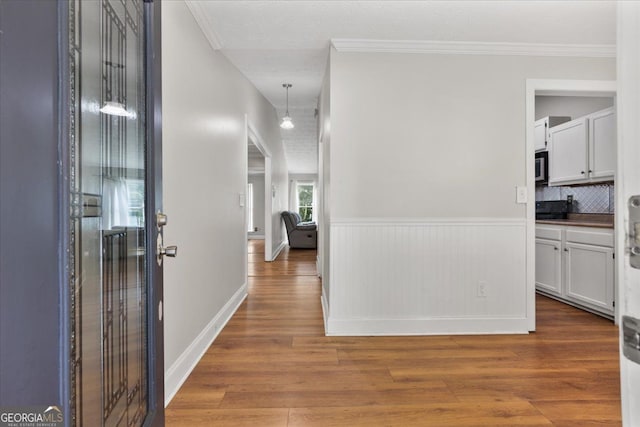 3357 Saddleton Way, Douglasville, GA 30134 - corridor with wood finished floors, crown molding, and wainscoting