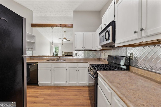 3357 Saddleton Way, Douglasville, GA 30134 - kitchen with appliances with stainless steel finishes, a sink, white cabinetry, beam ceiling, and a textured ceiling