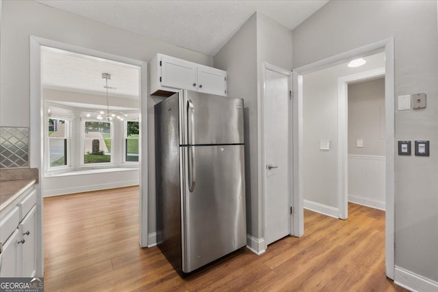 3357 Saddleton Way, Douglasville, GA 30134 - kitchen with freestanding refrigerator, light wood-type flooring, white cabinetry, and light countertops