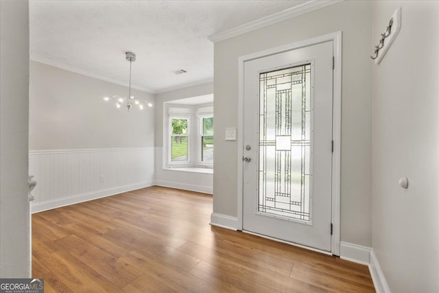 3357 Saddleton Way, Douglasville, GA 30134 - foyer with ornamental molding, wood finished floors, a wainscoted wall, and a chandelier