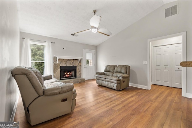 3357 Saddleton Way, Douglasville, GA 30134 - living area with vaulted ceiling, light wood-style flooring, ceiling fan, a fireplace, and baseboards