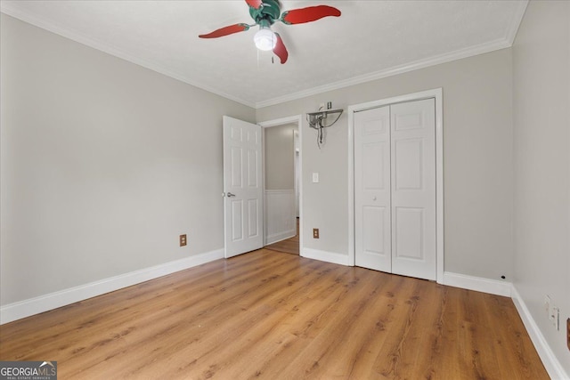 3357 Saddleton Way, Douglasville, GA 30134 - unfurnished bedroom featuring light wood finished floors, baseboards, ornamental molding, a closet, and a ceiling fan