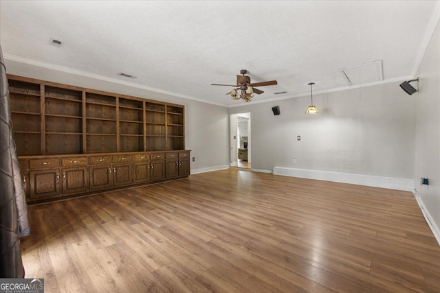 3357 Saddleton Way, Douglasville, GA 30134 - unfurnished living room with attic access, ceiling fan, baseboards, crown molding, and wood finished floors