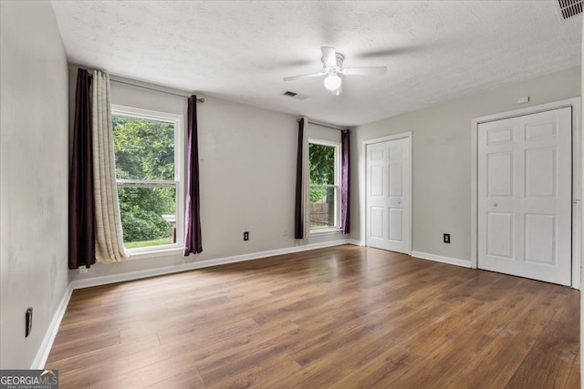 3357 Saddleton Way, Douglasville, GA 30134 - unfurnished bedroom with wood finished floors, a textured ceiling, baseboards, and a ceiling fan
