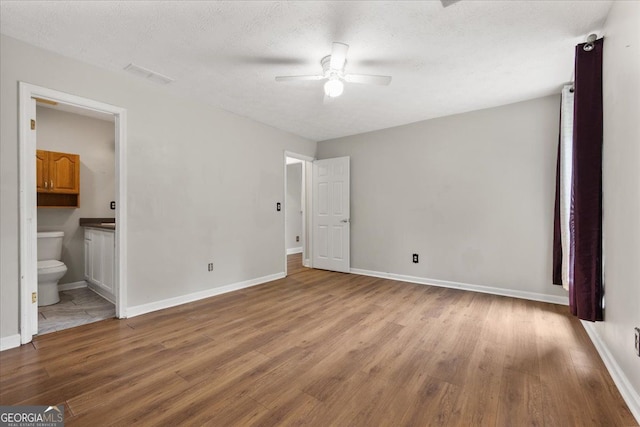 3357 Saddleton Way, Douglasville, GA 30134 - unfurnished bedroom with wood finished floors, baseboards, ensuite bathroom, and ceiling fan