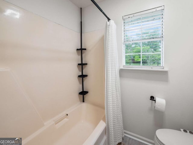 150 Archer Rd, Colbert, GA 30628 - bathroom featuring baseboards, shower / bath combo, and toilet