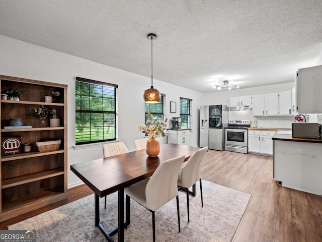 150 Archer Rd, Colbert, GA 30628 - dining room featuring plenty of natural light, light wood finished floors, and a textured ceiling