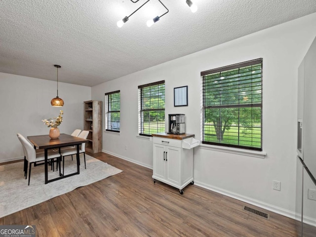 150 Archer Rd, Colbert, GA 30628 - dining room featuring dark wood-style floors, a textured ceiling, and baseboards